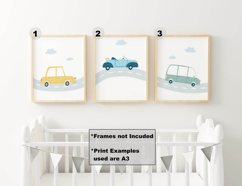 Three vibrant car prints from Wall Funk above a crib. Features yellow, blue, and green cars on roads. Ideal for boys' nursery decor.