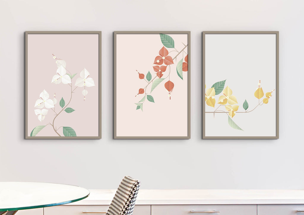 Three Floral Abstract Wall Art prints by Wall Funk hang above a modern dining area on a white wall.