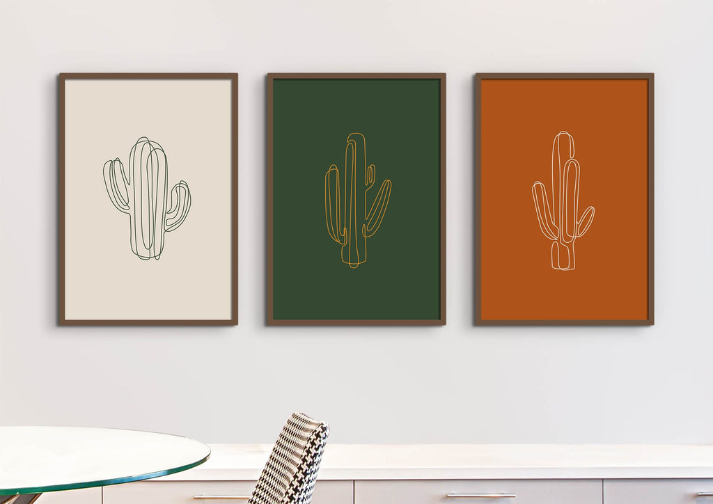 Floral Abstract Wall Art by Wall Funk: Three framed cactus line drawings above a table and chair on vibrant backgrounds. Sizes custom.