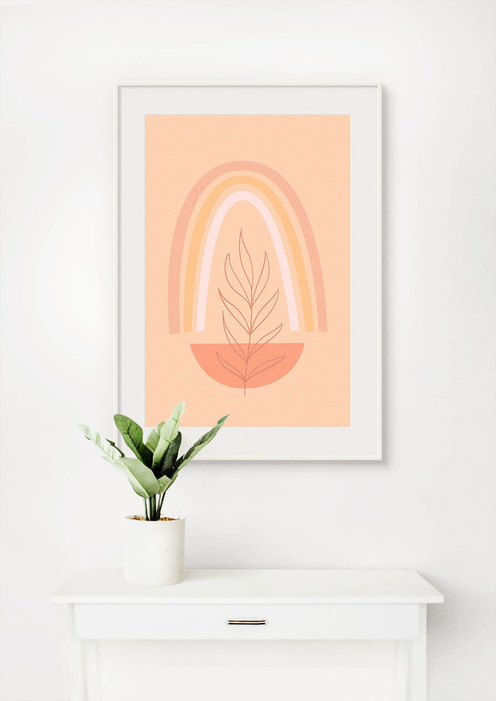 The Floral Abstract Wall Art by Wall Funk features a rainbow and leaf on peach, enhanced by a potted plant on a white table.