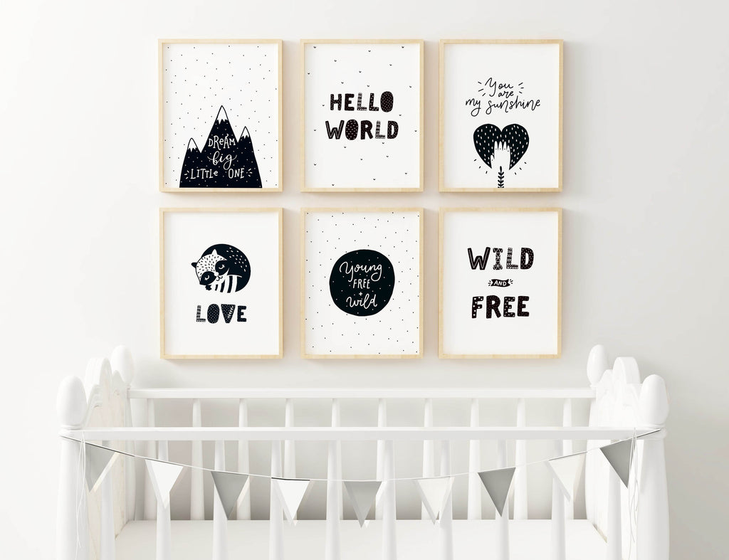 Charming Boho nursery art prints by Wall Funk adorn the wall above a white crib with bunting, adding inspirational and joyful designs.