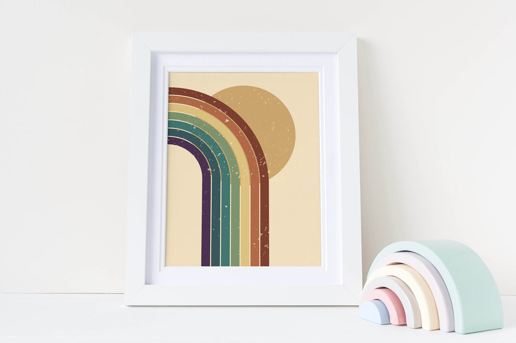 Wall Funk's Stylish Minimalist Children's Rainbow Art Prints sit next to a pastel rainbow ornament on a white surface.