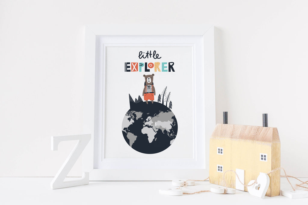 A framed "Little Explorer" bear print by Wall Funk, perfect for nurseries with a wooden house and letter "Z". High-quality card.