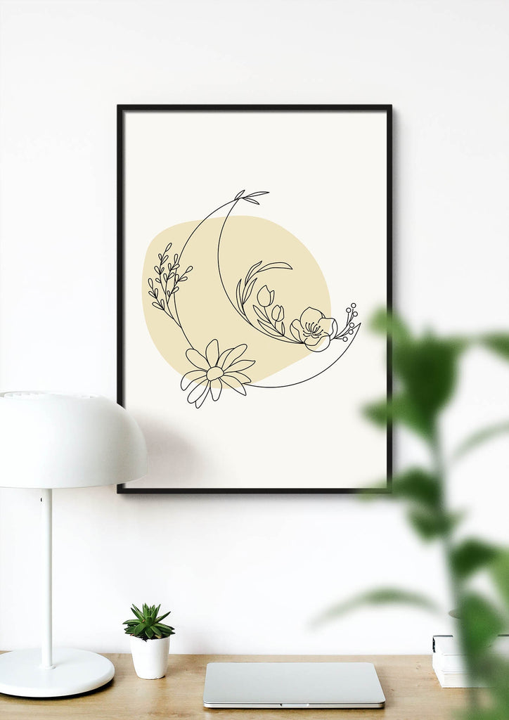 Wall Funk's "Floral Abstract" art in a black frame adorns a white wall above a wooden desk with a lamp, plant, and notebook.