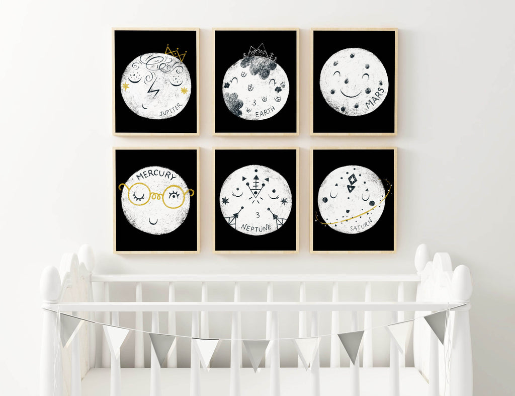 Wall Funk’s Cute Sleepy Planets art showcases Jupiter, Earth, Mars, Mercury, Neptune & Saturn above a white crib.