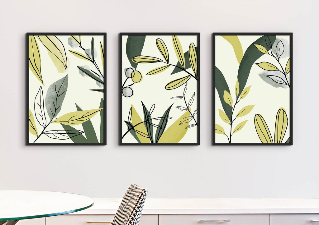 Wall Funk's Floral Abstract Wall Art adorns a white wall with its green and yellow leaf designs above a table and chair.