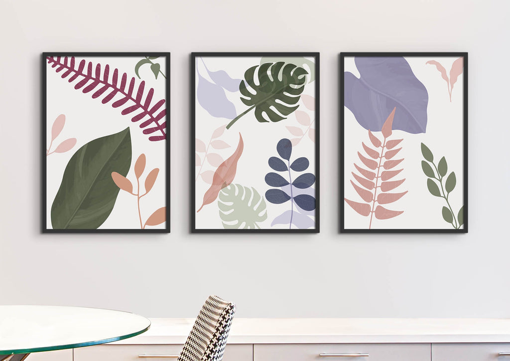 Light Pastel Floral Leaves Abstract Boho Wall Art Prints by Wall Funk hang above a table and chair, available in custom sizes.