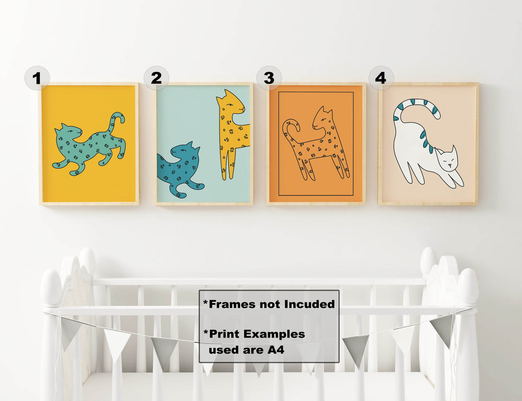 Four Charming Cat A4 prints by Wall Funk above a crib with bunting; frames not included.