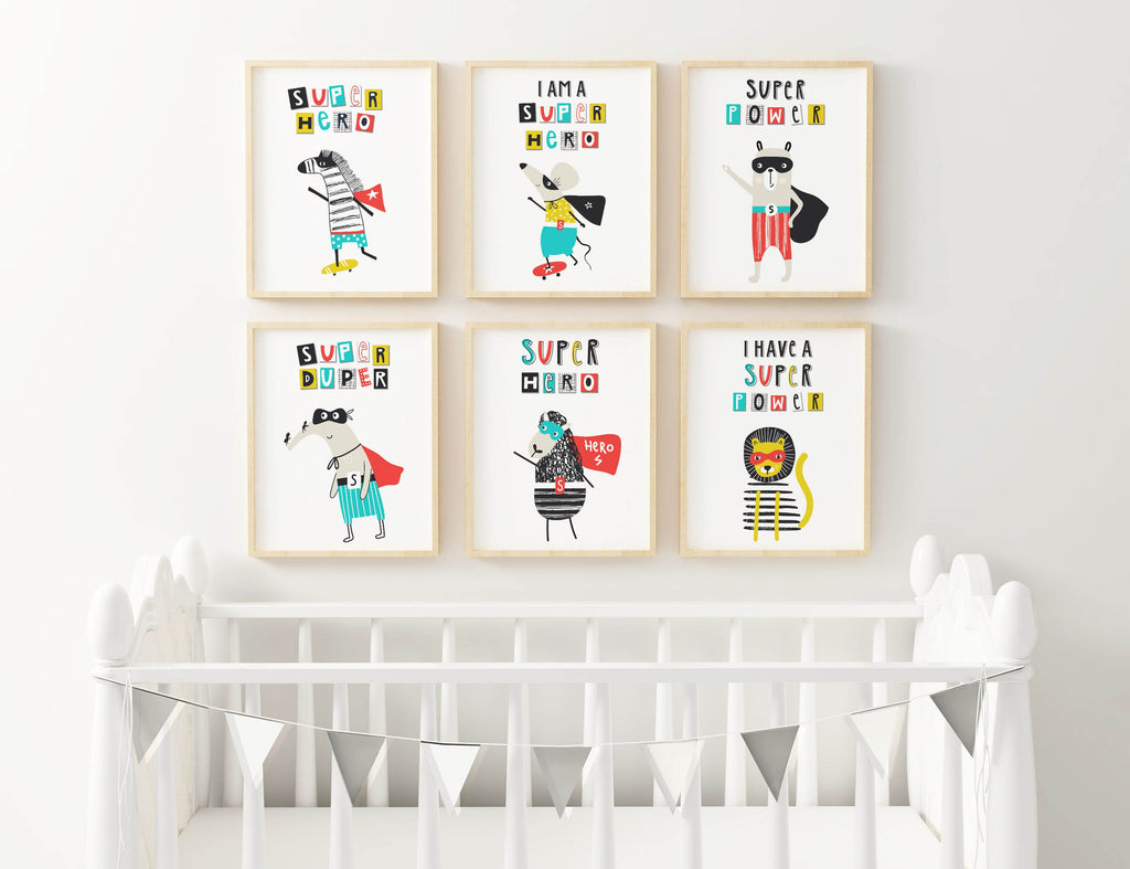 Nursery with Wall Funk's custom-sized animal superhero prints above a white crib and gray bunting. .