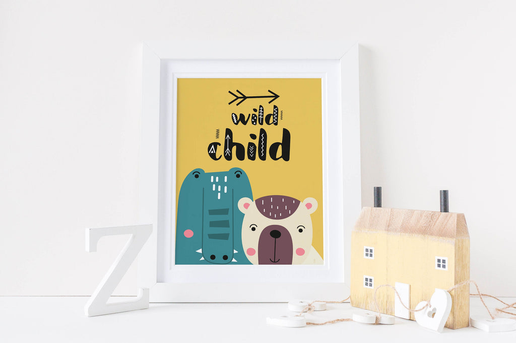 Whimsical nursery art print with cartoon bear and hippo on yellow background, text reads "wild child." Decor includes house & letter "Z".