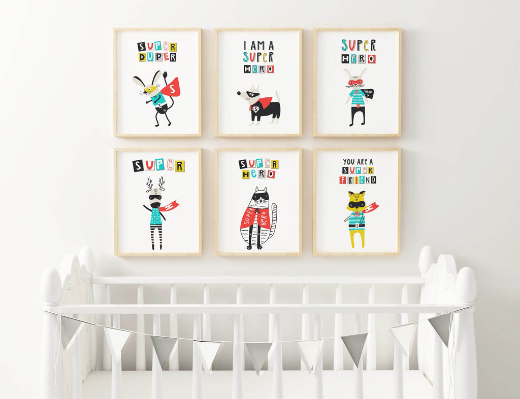 Six framed superhero animal nursery prints above a white crib with triangular bunting, customizable sizes by Wall Funk NP#91.