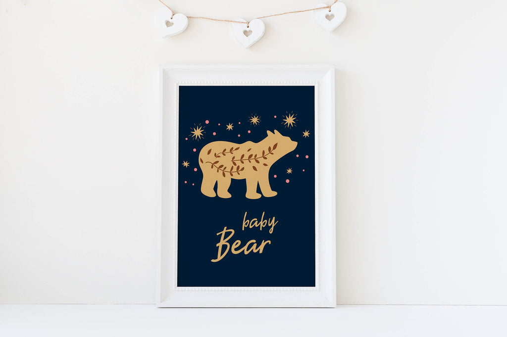 Introducing Wall Funk's "Boho Nursery Art Prints" NP#60: Adorn your nursery with these high-quality children's prints featuring a "baby Bear" design. The art showcases a gold bear silhouette set against a navy background embellished with stars, complete with an enchanting heart garland. Custom sizes are available to perfectly fit your space.