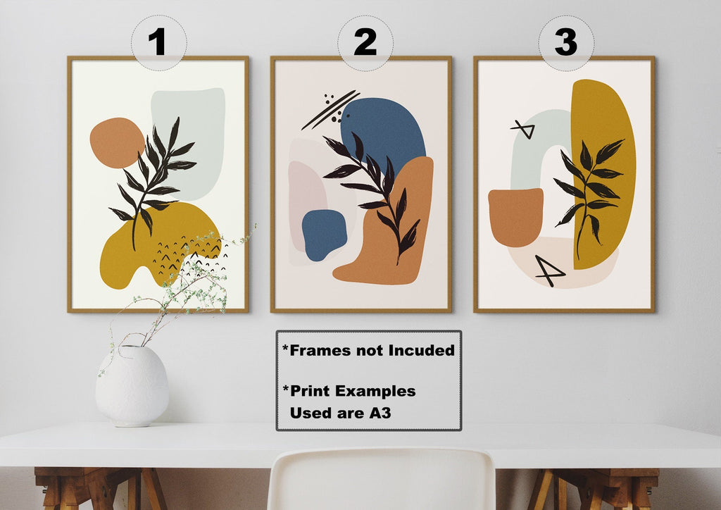 Three "Floral Abstract Wall Art" prints by Wall Funk, numbered 1-3, in earthy tones above a white vase on a wooden table.