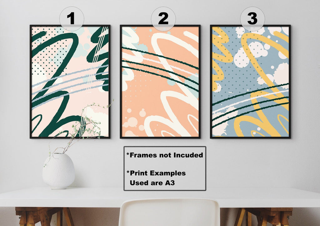 The Vibrant Abstract Art Prints by Wall Funk add bold wavy designs in teal, peach, and yellow above a white table.