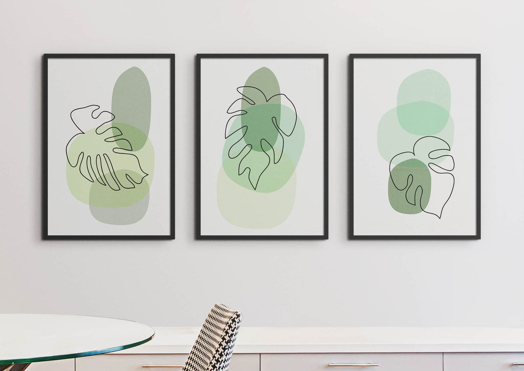 Wall Funk's Floral Abstract Wall Art prints with minimalist green shapes adorn a white wall above a sleek table and checkered chair.