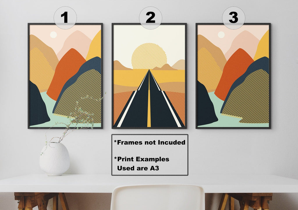 Above the desk, three Wall Funk art prints show stylized mountains and a road. A white vase completes the look.