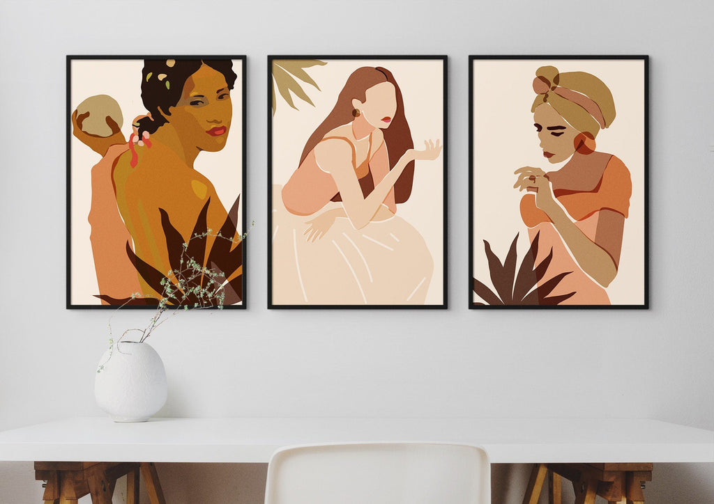 Beautiful Ethnic Women Modern Abstract Floral Wall Art Prints by Wall Funk elegantly hang above a table with a vase.