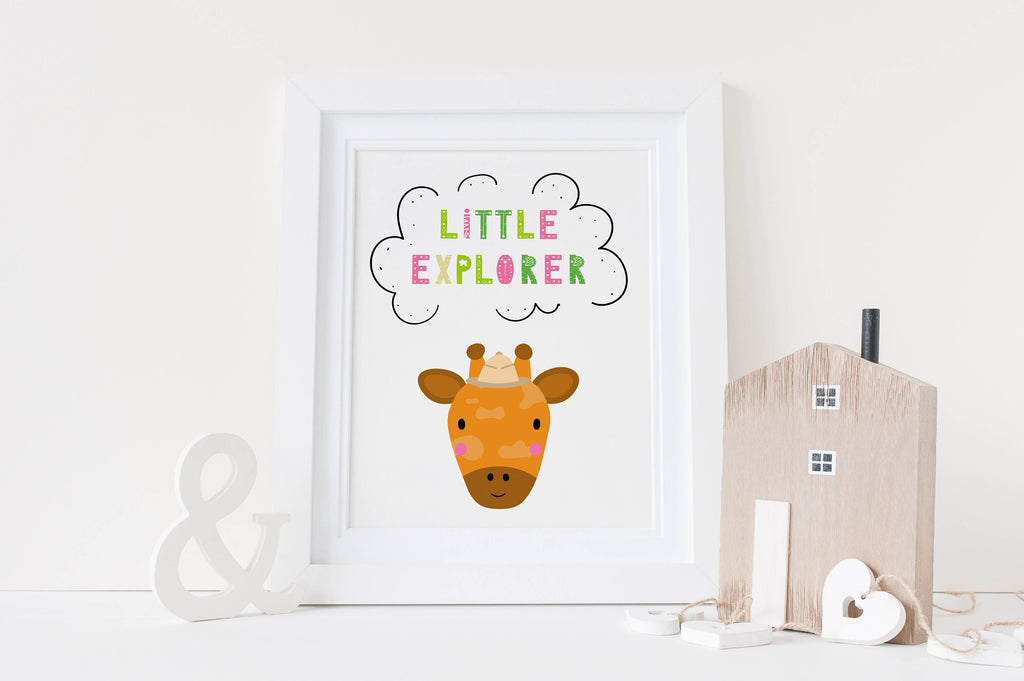 Wall Funk's "Little Explorer" giraffe print with decor pieces (house & ampersand) on a white surface adds charm to any nursery.