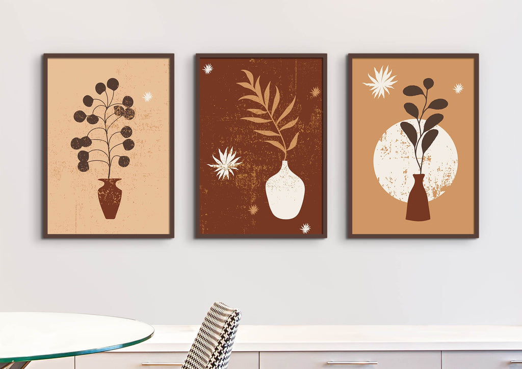 The Floral Abstract Wall Art by Wall Funk includes three minimalist framed prints on quality card above a table and chair.