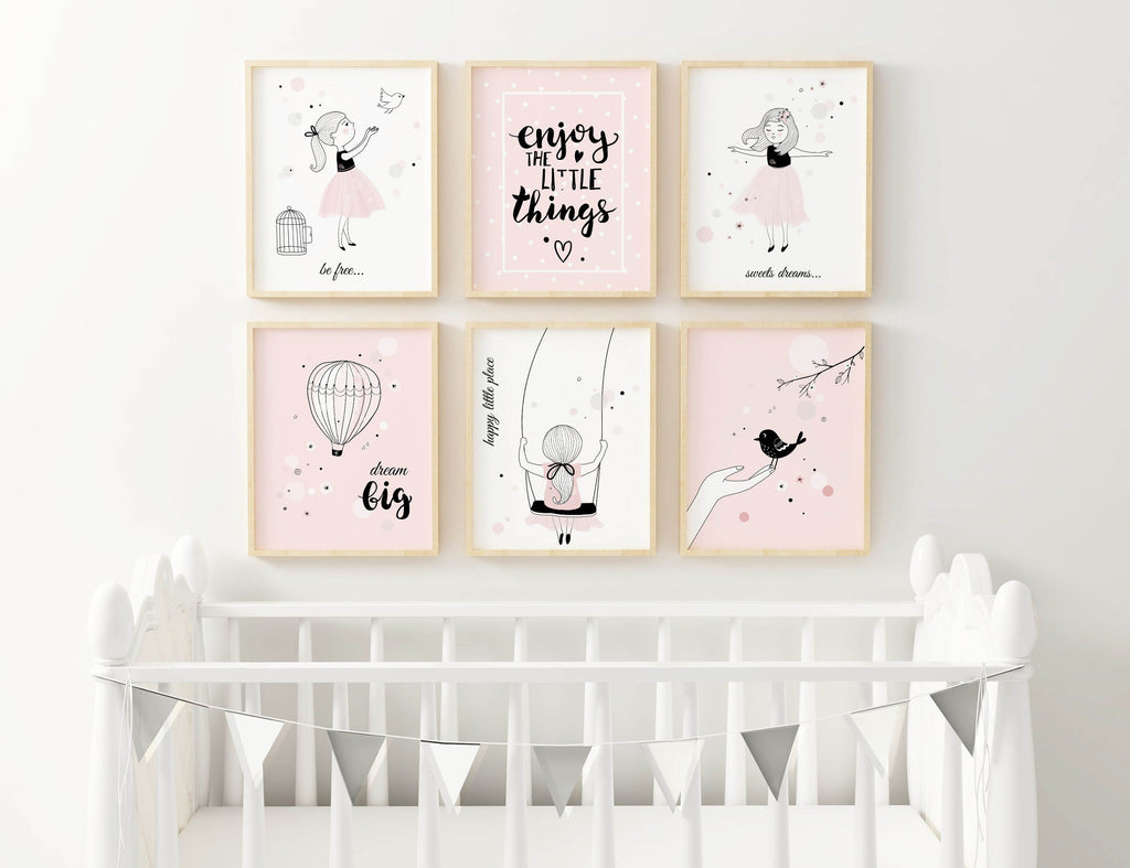 A cosy nursery with a Wall Funk Boho art set of uplifting quotes and pastel illustrations; white crib adorned with a garland.