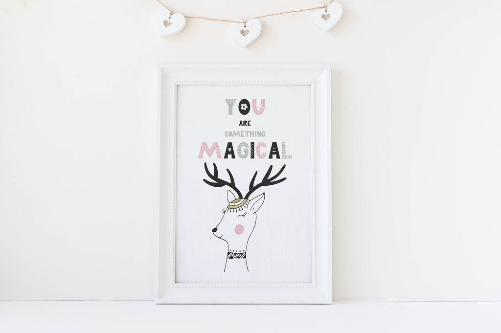 Wall Funk's nursery art print features a deer with "You are something magical" and handing heart decorations above.