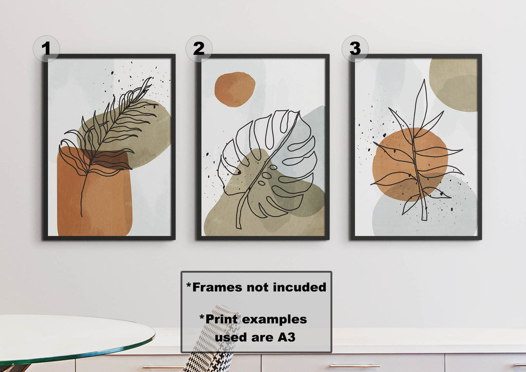 Three minimalist Floral Abstract Wall Art prints by Wall Funk feature botanical designs in earthy tones, framed in black on high-quality card.