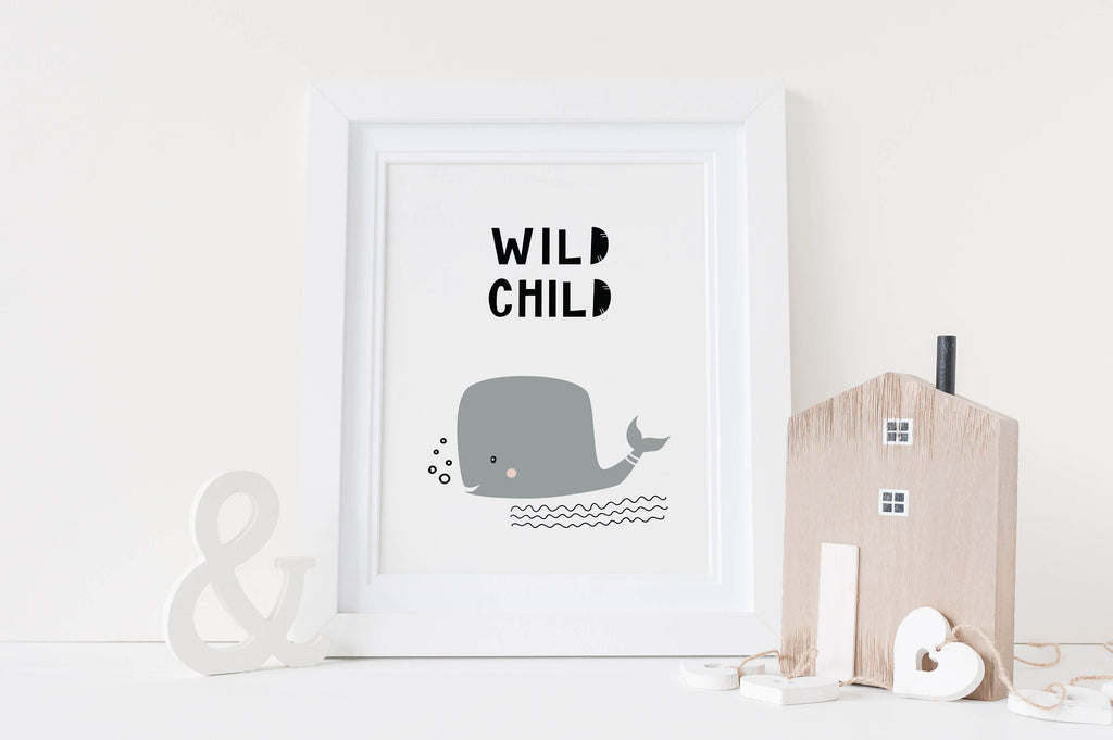 Wall Funk's Scandinavian Nursery Prints feature a whimsical gray whale with "WILD CHILD" text, alongside wooden decor.