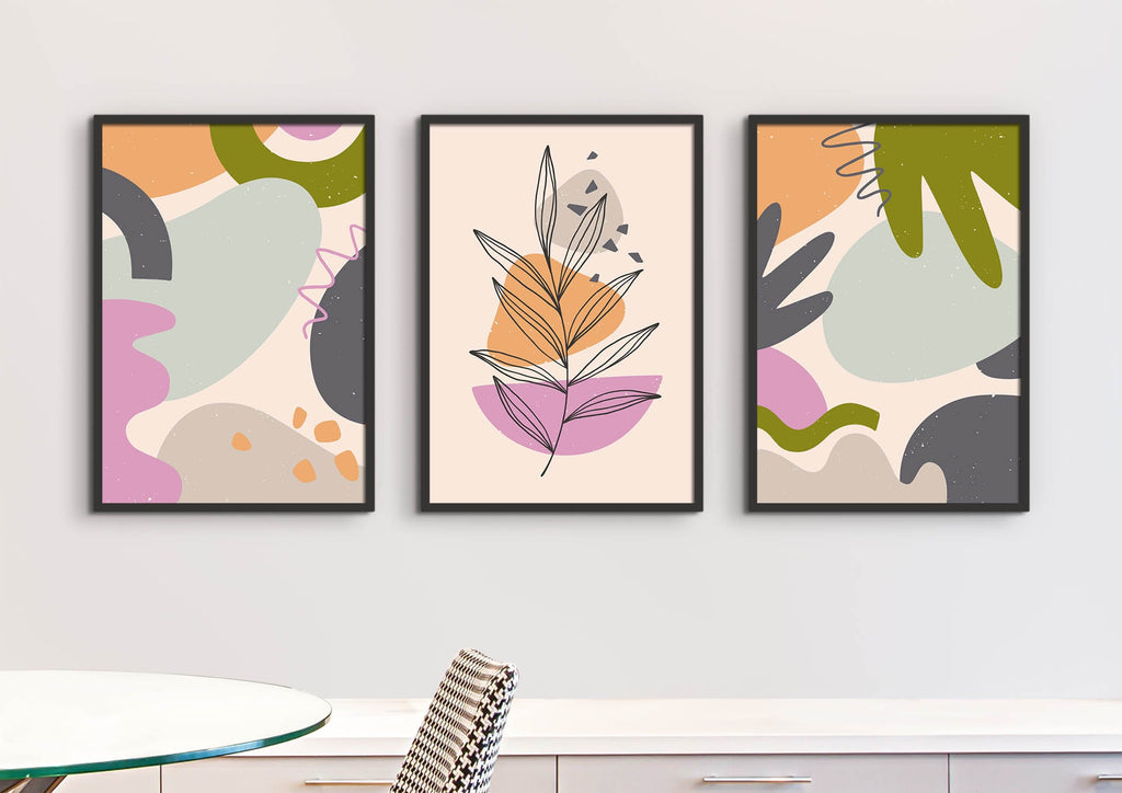 Three Wall Funk prints on a wall: two with colorful geometric shapes and one Floral Abstract Wall Art in pastel shades.