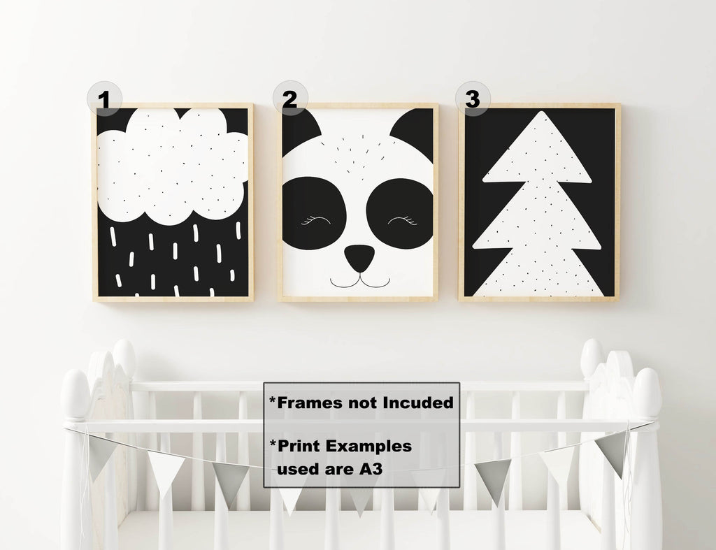 Wall Funk's NP#49 includes panda, rain cloud, and tree nursery prints. Black and white designs above a crib. Frames not included.