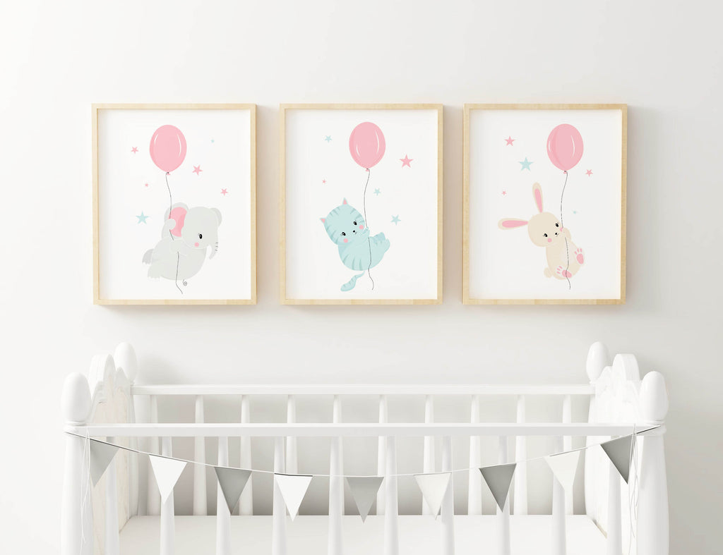 Wall Funk's Nursery Art Prints, featuring a bear, cat, and rabbit with balloons on pastel backgrounds, are framed above a white crib.