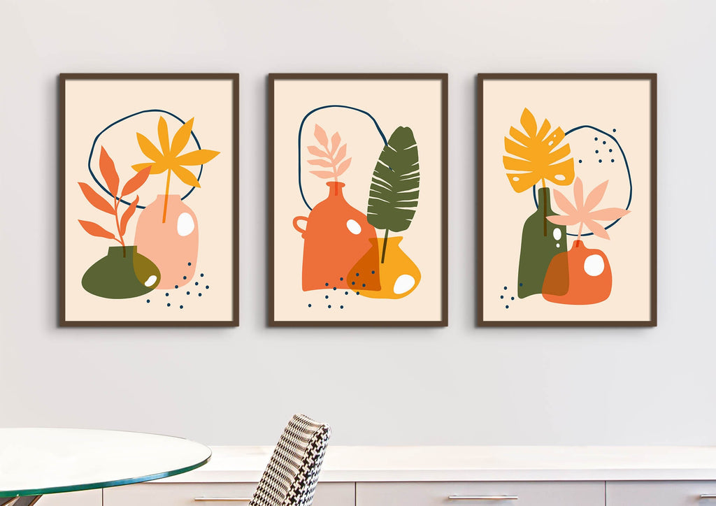 Floral Abstract Wall Art from Wall Funk features three vibrant prints adorning a light-toned wall above a minimalist table and chair.