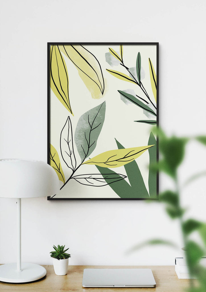 Wall Funk's Floral Abstract Wall Art with green and yellow leaves decorates a wall behind a lamp, plant, and closed laptop. Custom sizes!.