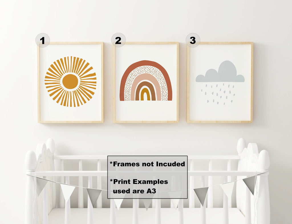 Wall Funk's Nursery Art Prints, featuring a sunburst, rainbow, and cloud with rain, hang above a white crib with a banner.