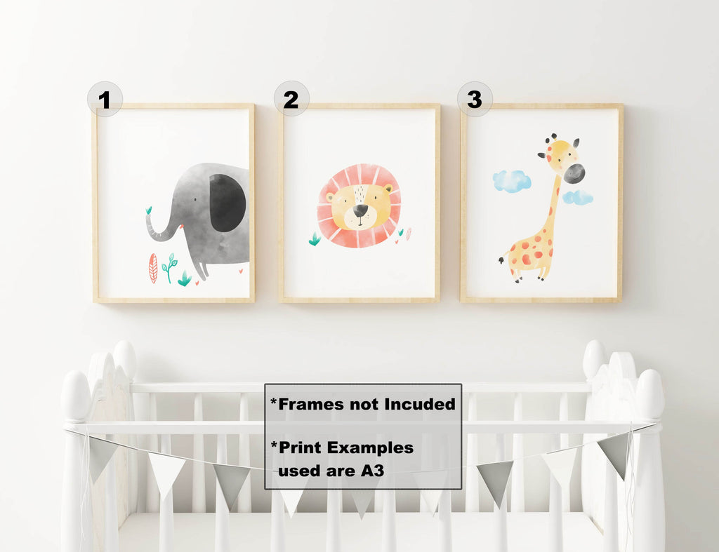 Three Safari Nursery Art Prints with an elephant, lion, and giraffe from Wall Funk hang above a crib. Custom sizes. Frames not included.