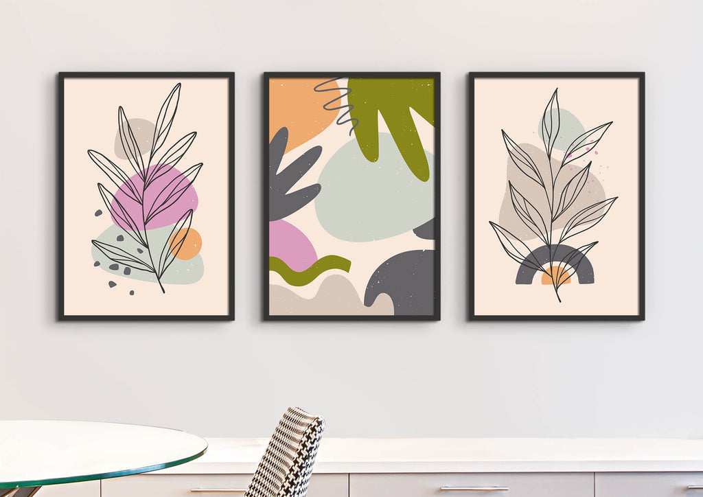 Wall Funk's Bold & Vibrant Floral Abstract Wall Art Prints add charm to a white wall above a table and chair.