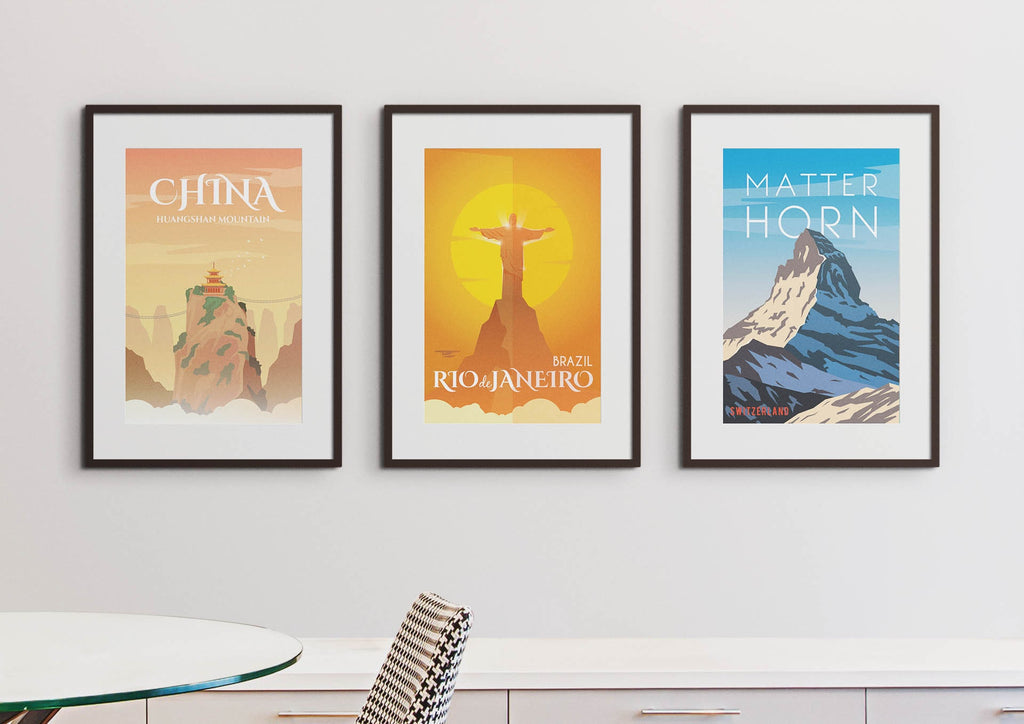 Three Wall Funk travel prints showcasing China, Brazil, and the Matterhorn hang on a white wall above a table. #TP#04.