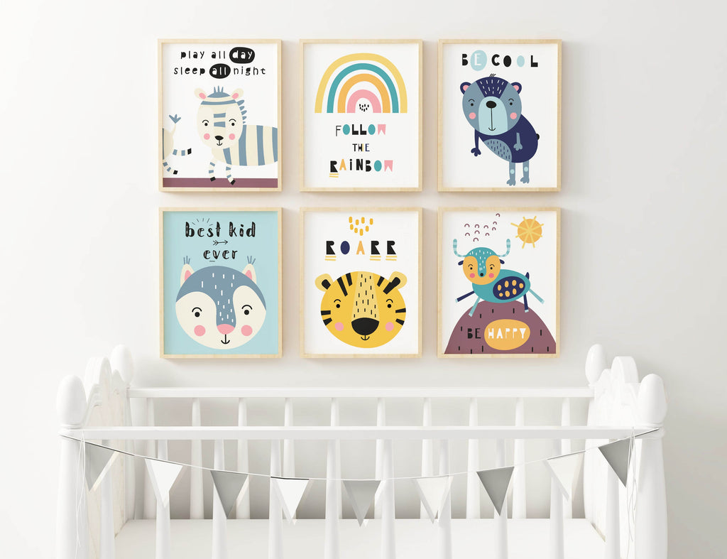 Above a white crib, six Wall Funk nursery prints with whimsical animals and rainbows are accented by a small bunting.