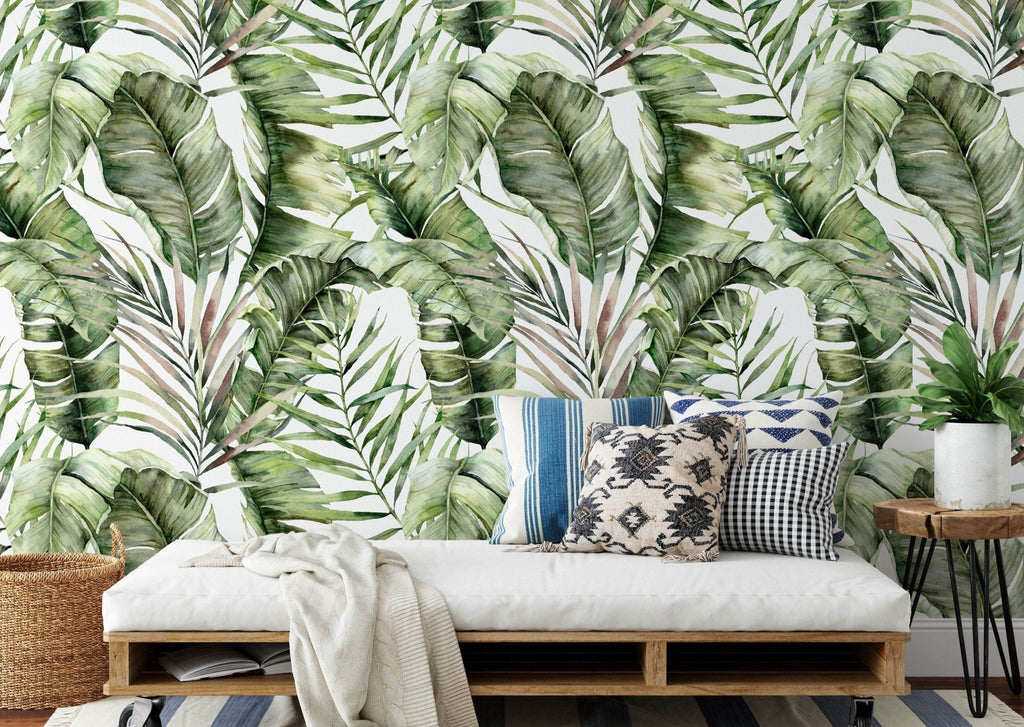 a living room with a couch and a wallpaper with green leaves