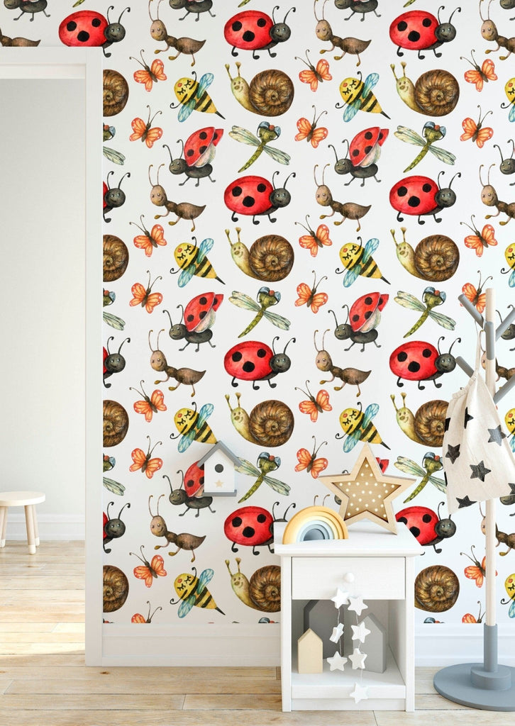 a room with a wallpaper with a pattern of ladybugs and snails