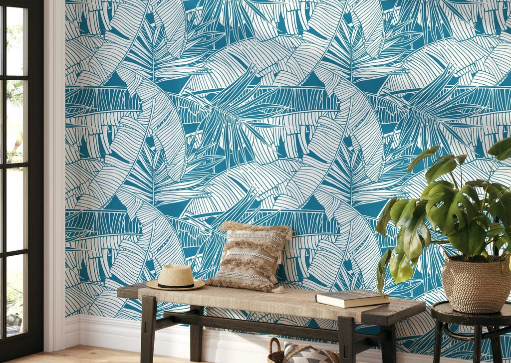 a bench in front of a blue leaf tropical wallpaper