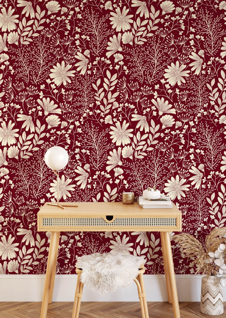 a red and white floral wallpaper with table
