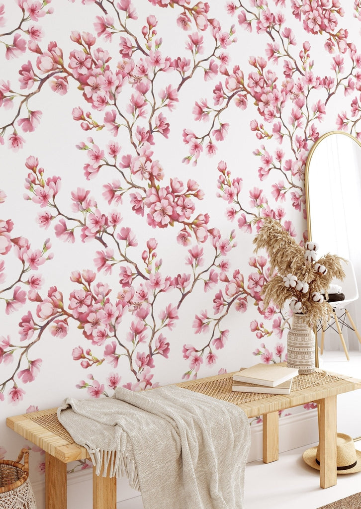 a room with a table, mirror, and pink floral wallpaper