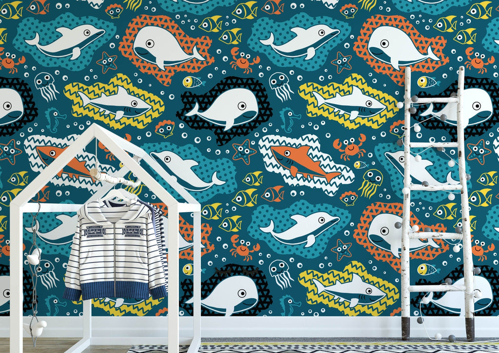 A child's room showcases a wall adorned with Wall Funk UK's Ocean Creatures Wallpaper Sample, perfectly color-matched to vibrant ocean hues. It also includes a white clothes rack shaped like a house.